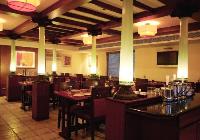 meenam - the south indian speciality restaurant. the faux chettinad pillars are made of glass and lit from inside. the base and capital are authentic chettinad pieces sourced from dismantled buildings.